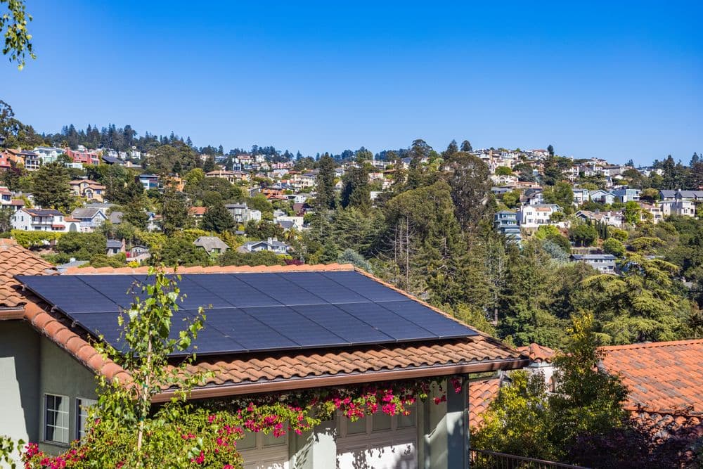 Solar panels on a residential roof overlooking the city